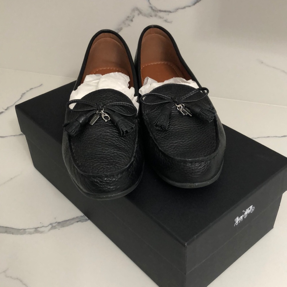 Black loafers with tassels by Coach